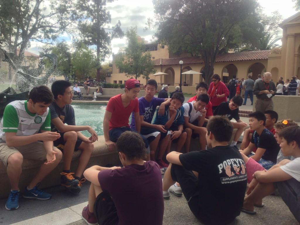 Edward Ngai, class of 2011 (third from the left), chats with Saints swimmers on Stanfords sunny campus.