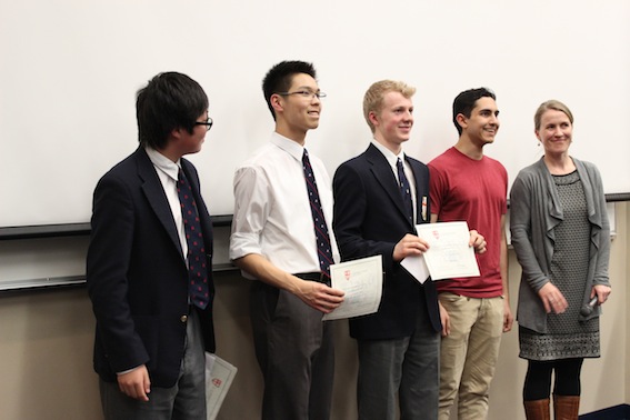 Allen Chak (gr. 9), Alan Wong (gr. 10), Kieran Halliday (gr. 11) and Aman Malhotra (gr. 12) receive awards as top performers in the school-wide Poetry in Voice Championships from Mrs. Katrina OConnor, English department head.