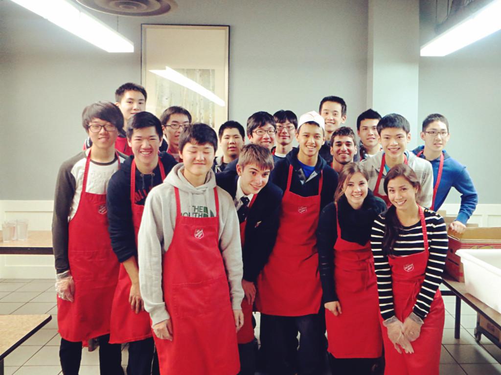 A few months after their initial visit, student volunteers, faculty member Ms. Sandra Gin, and student teacher Ms. Lena Kohler, from the local issues arm of the Global Perspectives and Community Service Club (GPACs) once again smile and gather inside the Harbour Light Soup Kitchen after a fulfilling morning of serving lunch to those in need on the Downtown East Side. 