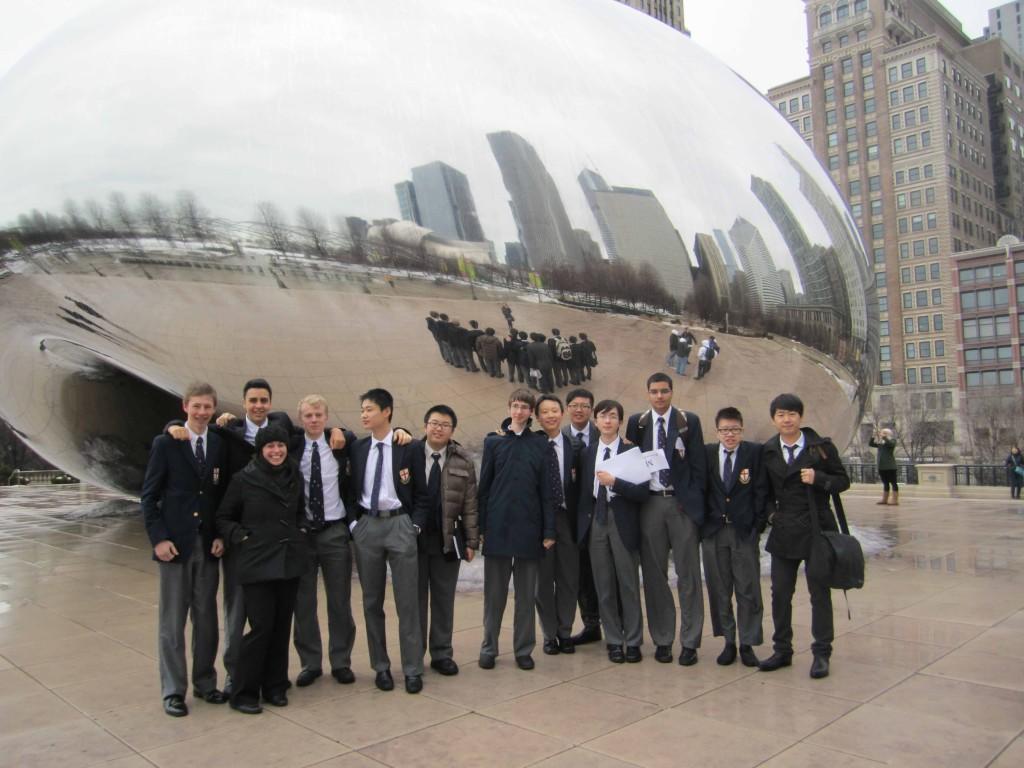 Students stand in front the citys iconic bean.