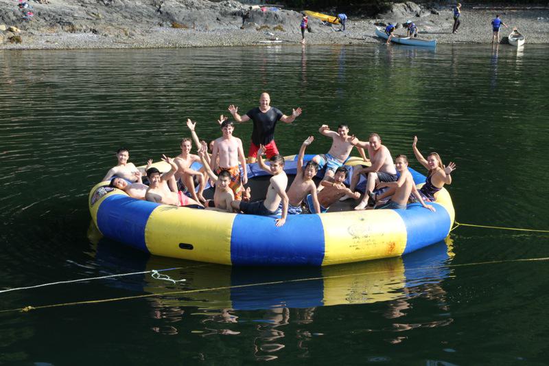 Boys and staff spend some time relaxing on the water trampoline.