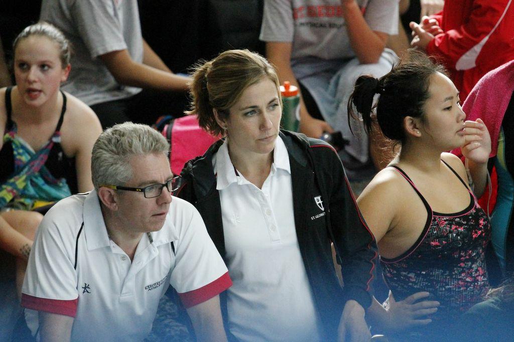 Mr. Sayers and Ms. Dill keeping track of swimmers' individual times.