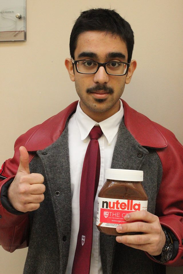 Kushal K. poses for the camera with The Creed Nutella in hand and the his stache above lip.