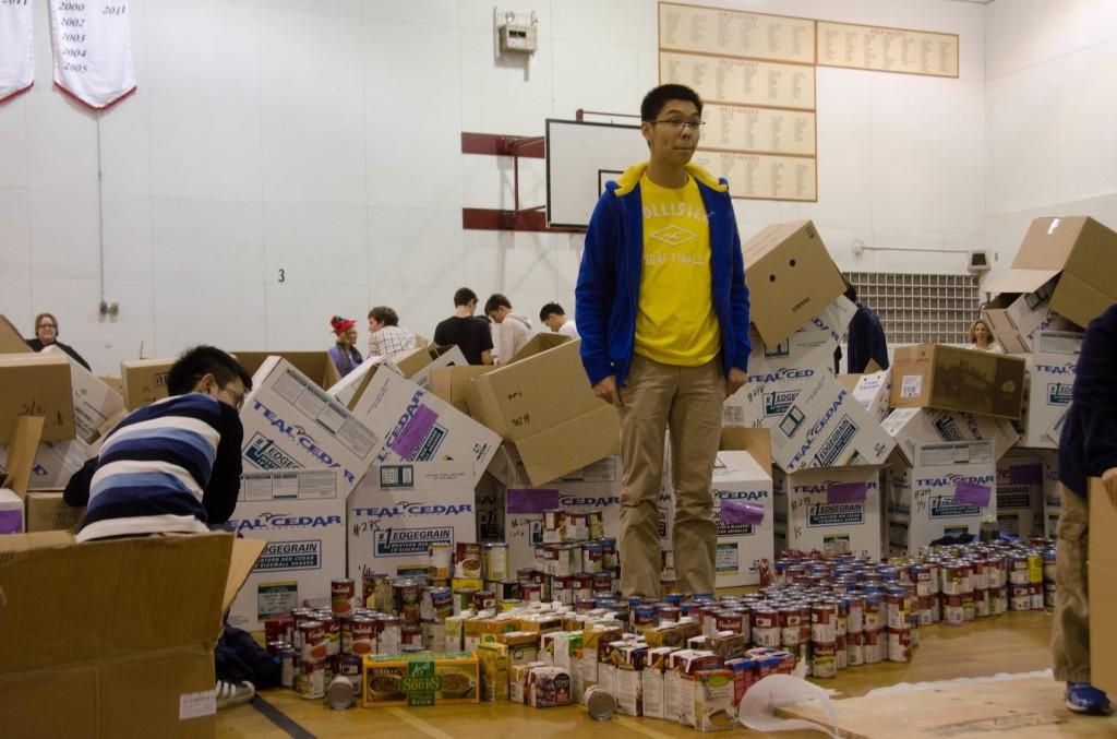 Alan Wong (grade 11) helps sort cans on Hamper Drive day