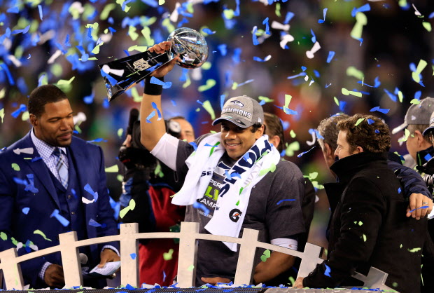 Russell Wilson holds the Vince Lombardi Trophy after defeating the Denver Broncos