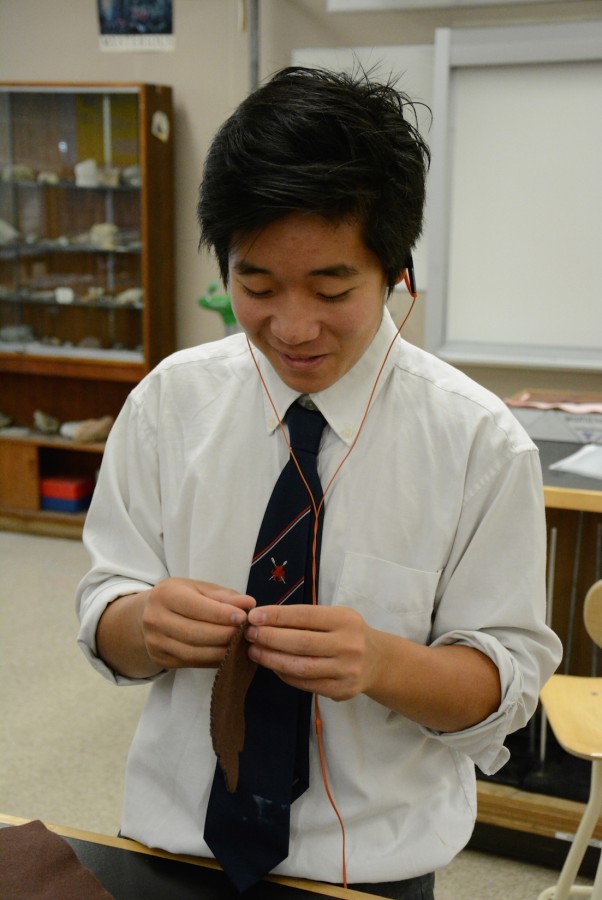 Kai Yung enjoys himself as he sews.
