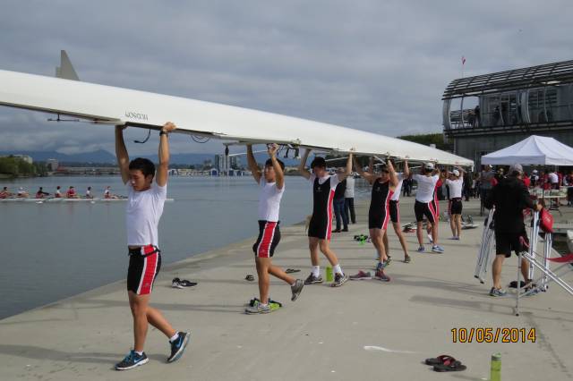 Junior A Rowers getting ready to place their boat on the water.