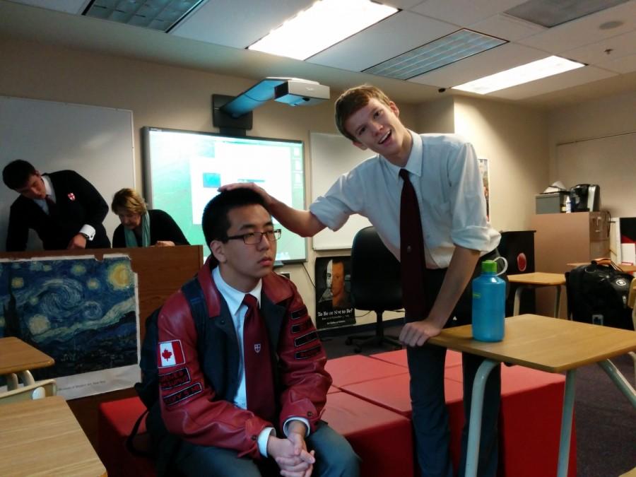 During Mrs. Schuetze’s grade twelve advisor sessions, student Jamie MacKay (right) must touch Donovan Zhao’s hair (left) at least once, simply because his hair is one-of-a-kind. Clearly, Donovan is unamused.
 