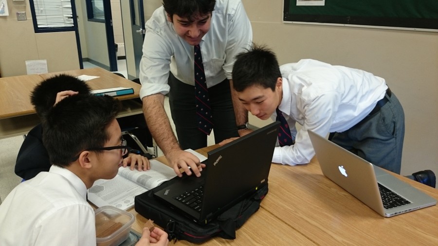 Ryan Karimi helps Yutong Zhang settle a deadly move on his computer Chess game against Conrad Breakell who is peaking over to plan his counter-attack as Harvey Lee observes carefully while snacking on some wafers. 