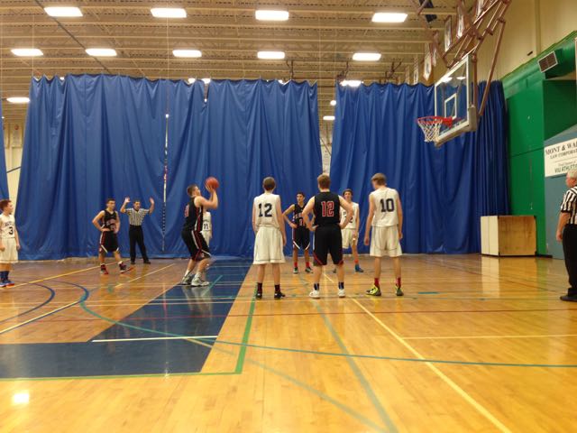 68 Jacob Van Santen (grade 10) towers over the rest as he shoots his free throws.