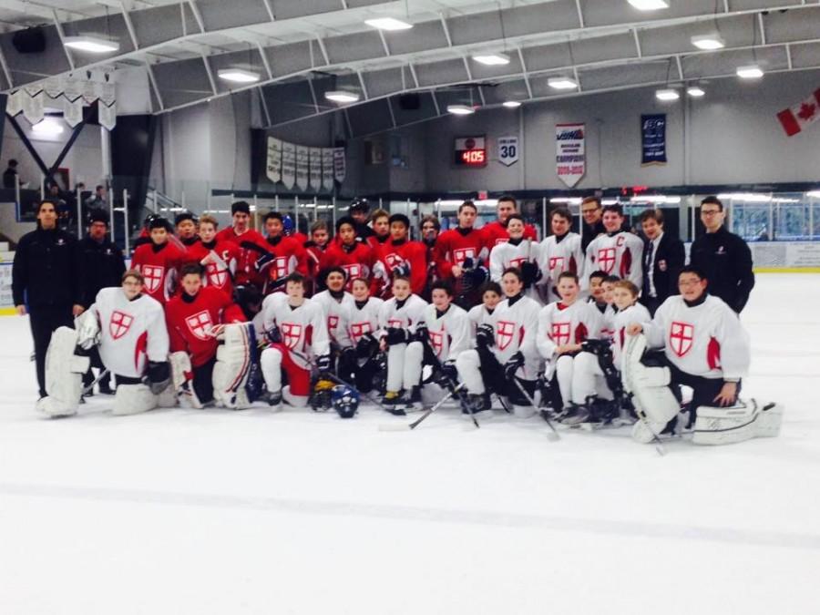 The JV and U-14 teams take a group photo after a hard fought game.