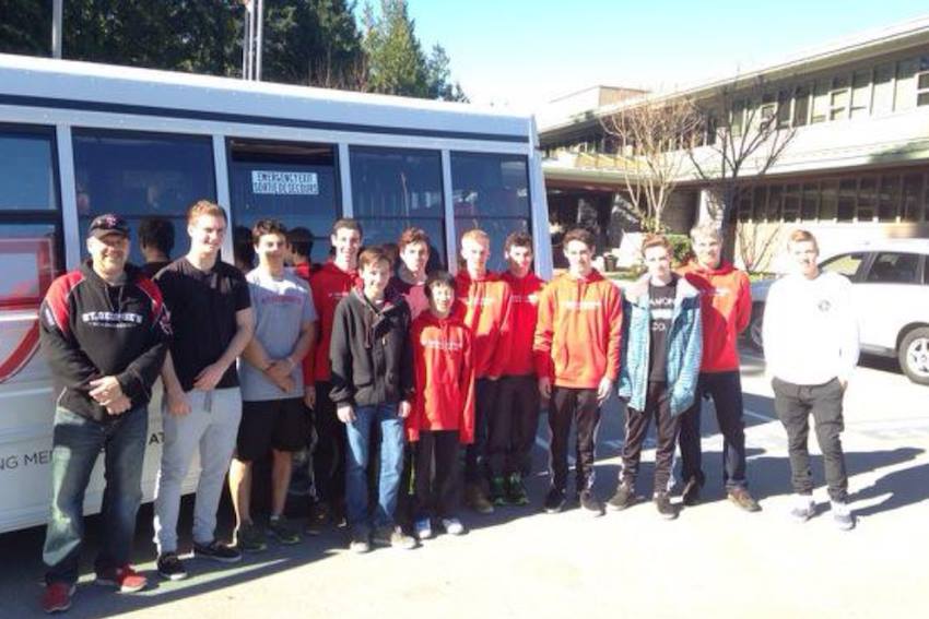 The skiers and snowboarders pose for a picture before the long bus ride to Revelstoke. 