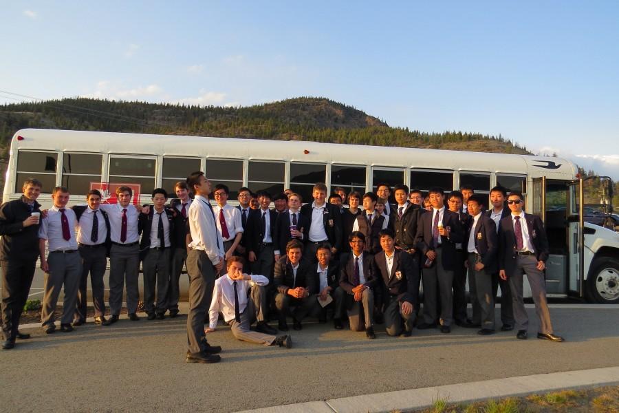 The Members of the Junior and Senior Jazz Band stand outside of the school bus in Kelowna.