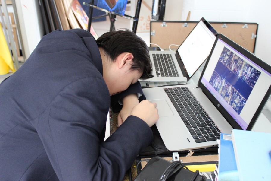 Ty Zhang (Grade 11) tired from looking at his computer