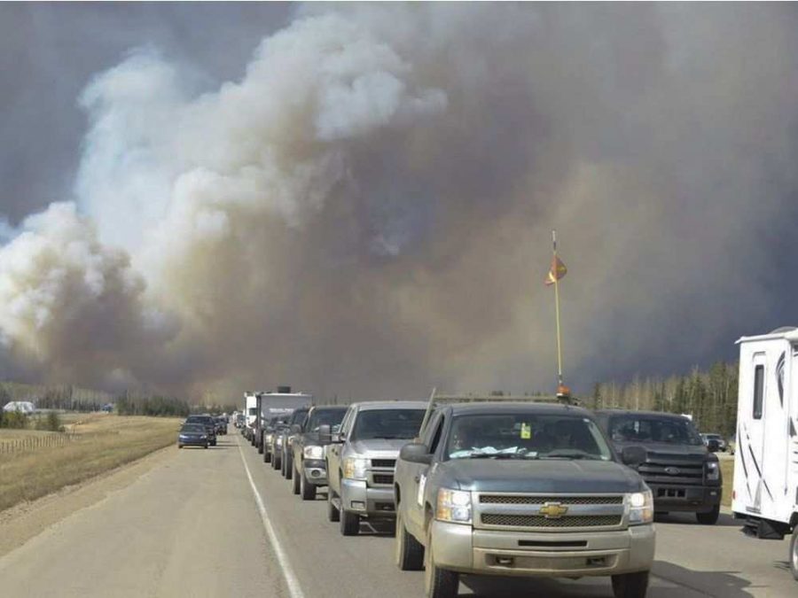 People driving away through the smoke.