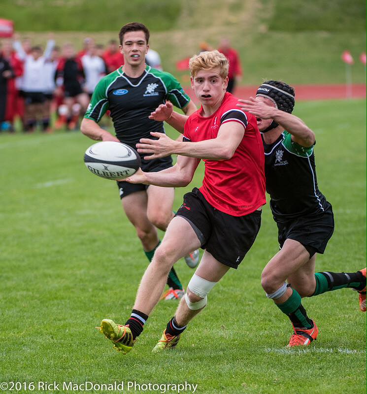 Greg Atkinson (12) dishes the ball away