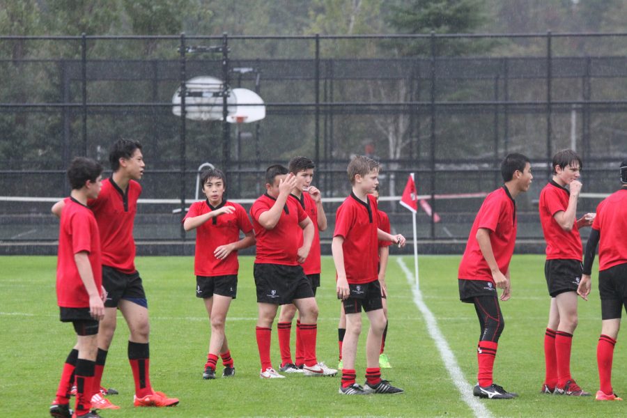 The Grade 9 rugby team line up for a scrum. 